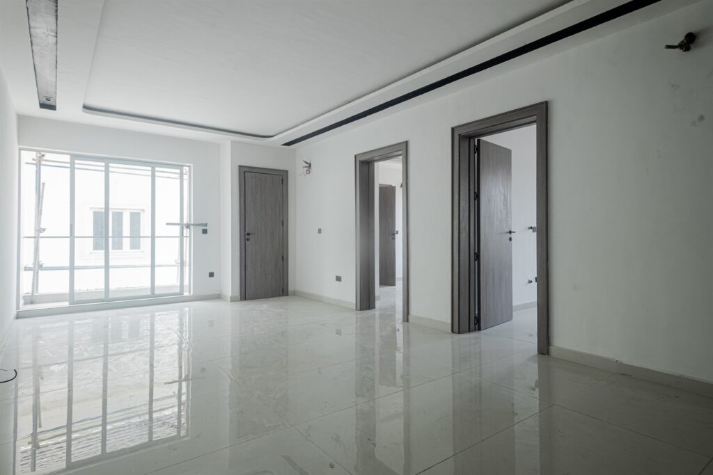 Brum Height 6: Bright living space beside glazed balcony doors